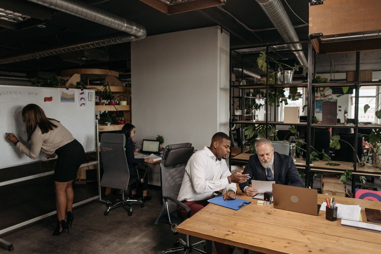 Diverse team collaborating in a modern office environment, planning strategy.